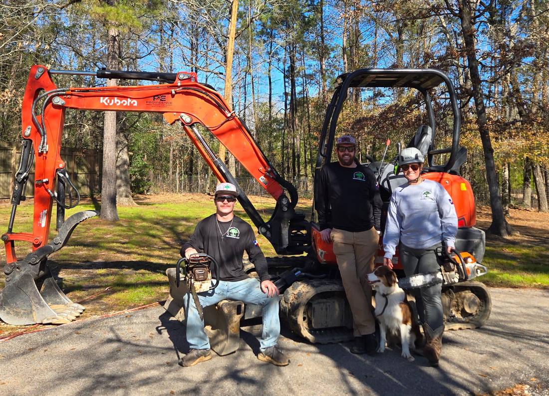 The Branching Out crew with their tracked excavator on a job site